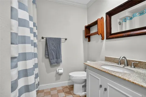 a bathroom with a granite countertop sink toilet a large mirror a vanity and shower
