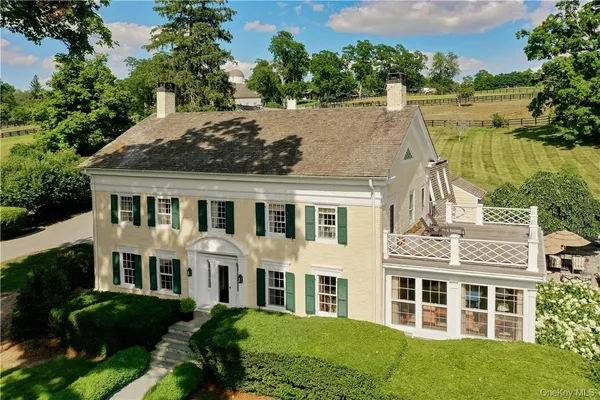 a aerial view of a house with a yard and potted plants