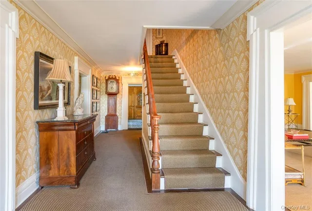 a view of entryway and hall with wooden floor