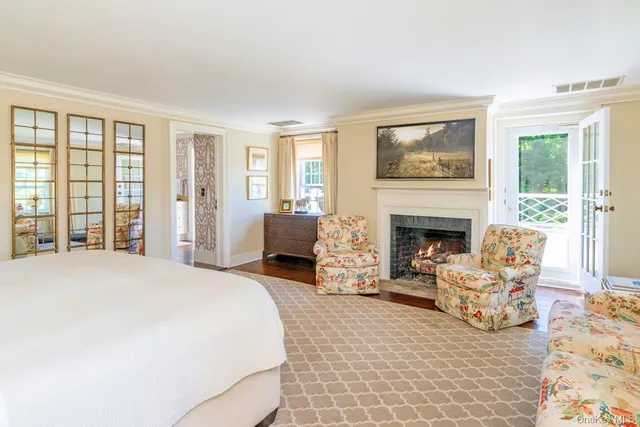 a bedroom with furniture and a fireplace