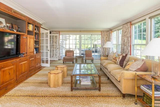 a living room with furniture cabinets and a flat screen tv