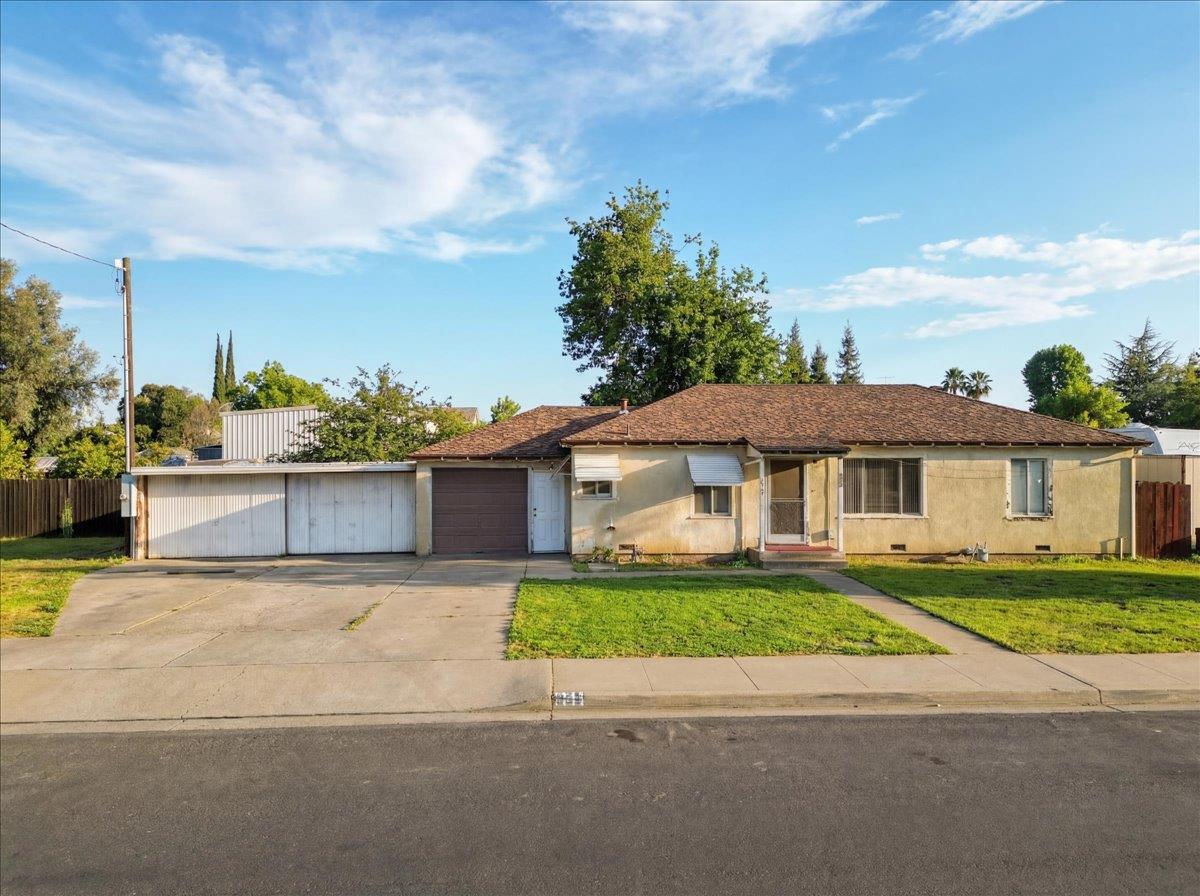 1833 Richard Way Ceres, CA 95307 - Photo 1 of 21 a white house with a yard and a large tree