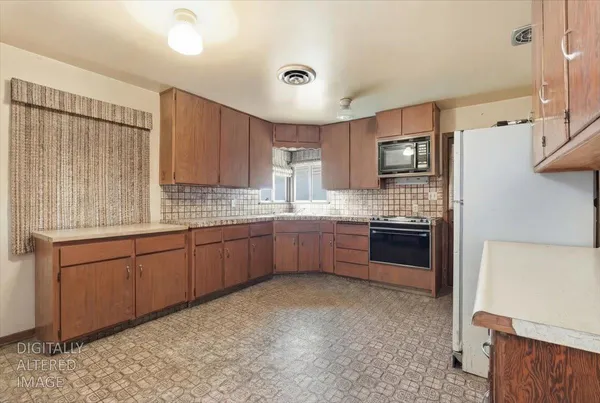 a kitchen with a sink cabinets and wooden floor
