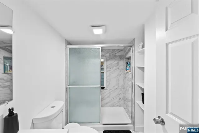 a bathroom with a shower and toilet