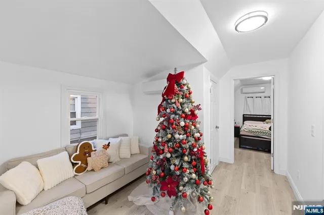 a living room with furniture and a christmas tree