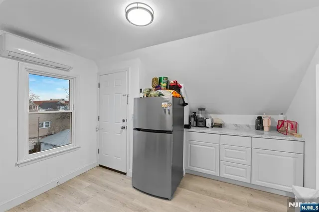 a kitchen with a refrigerator and cabinets