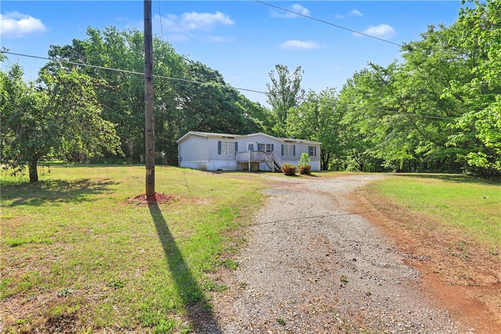 249 John Golden Road Temple, GA 30179 - Photo 3 of 45 a view of yard with swimming pool and trees in the background