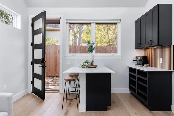 a kitchen with stainless steel appliances a sink cabinets and a table