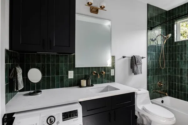 a bathroom with a sink a toilet a mirror and vanity