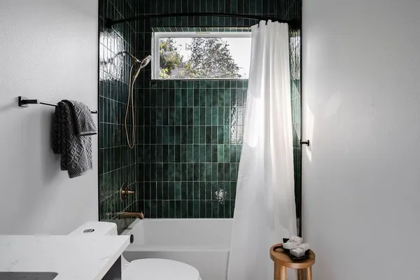 a bathroom with a toilet and a shower