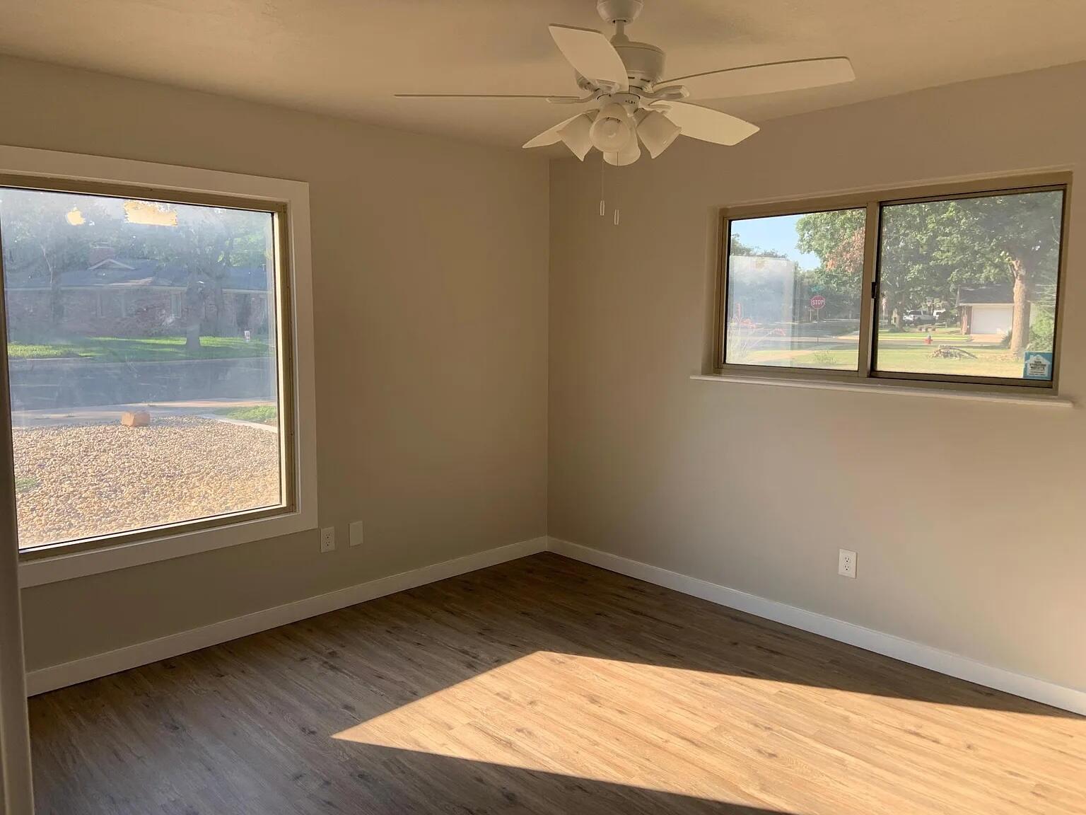 4120 62nd Drive Lubbock, TX 79413 - Photo 14 of 19 a view of an empty room with wooden floor and a window