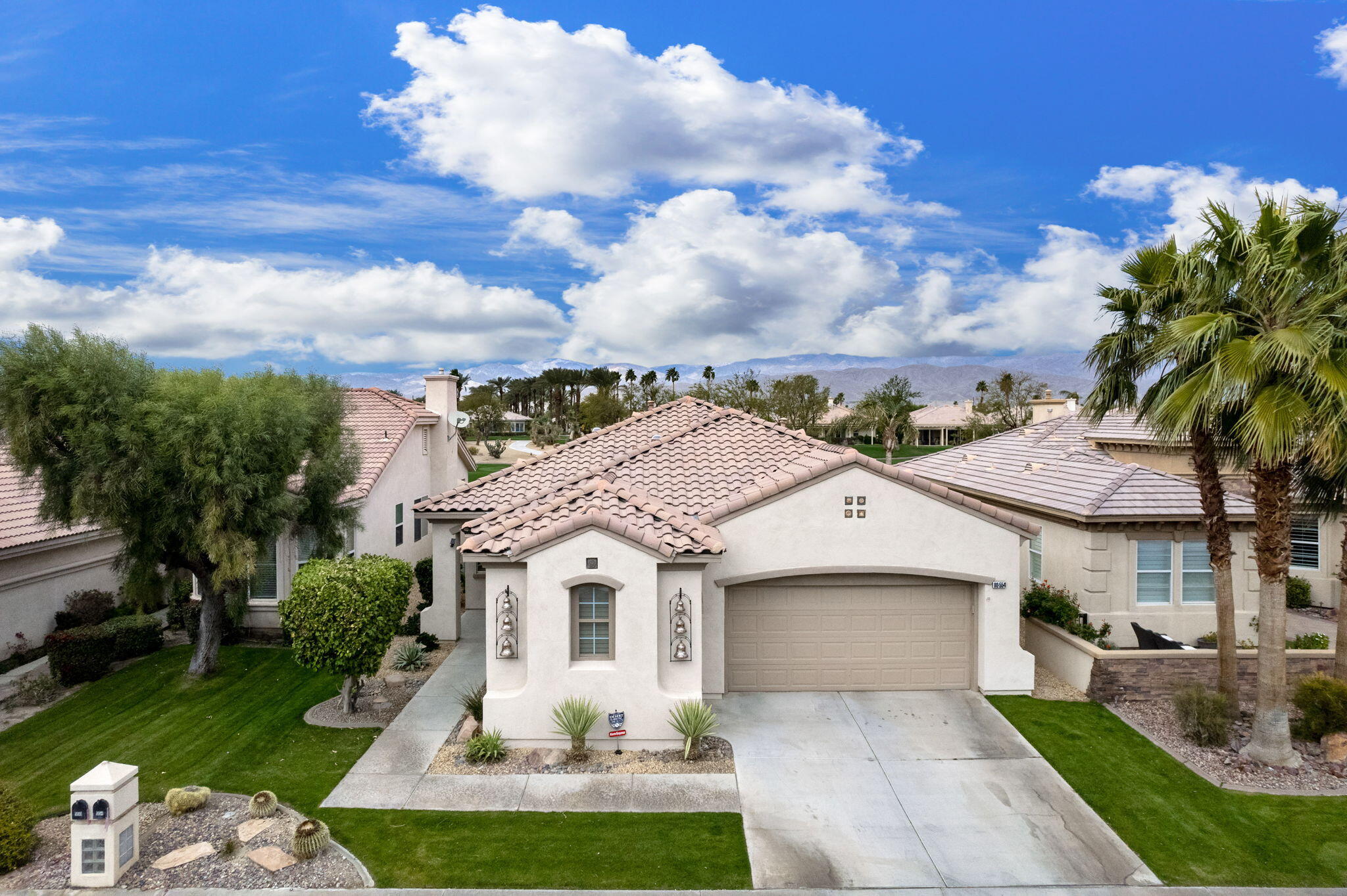 80554 Knightswood Road Indio, CA 92201 - Photo 1 of 44 a white building with a big yard and potted plants