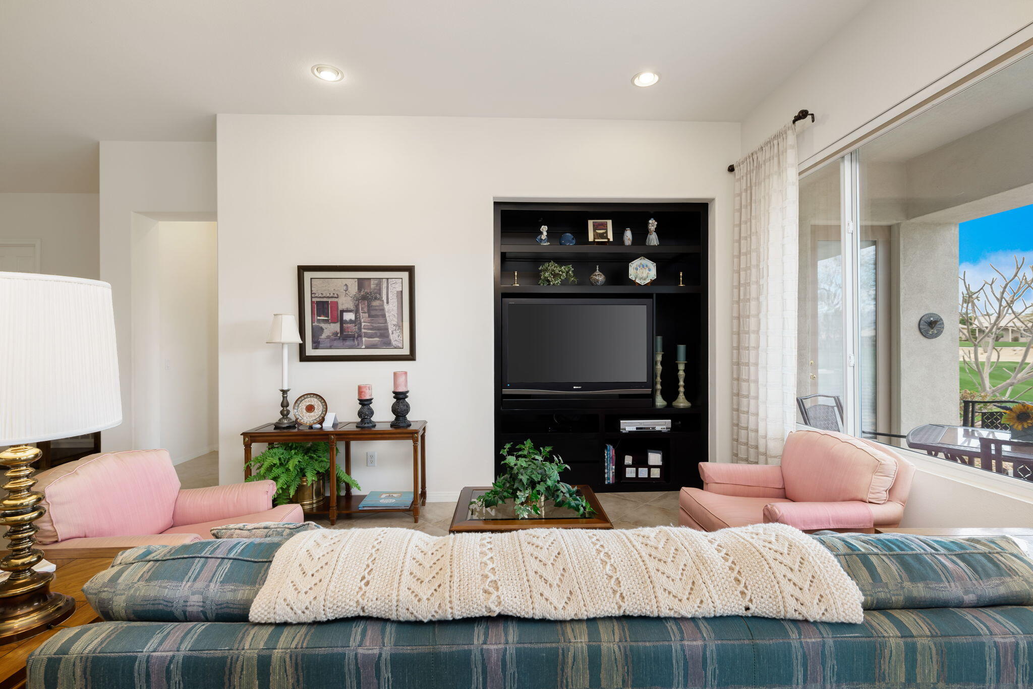 80554 Knightswood Road Indio, CA 92201 - Photo 14 of 44 a bedroom with a bed a couch and a flat screen television