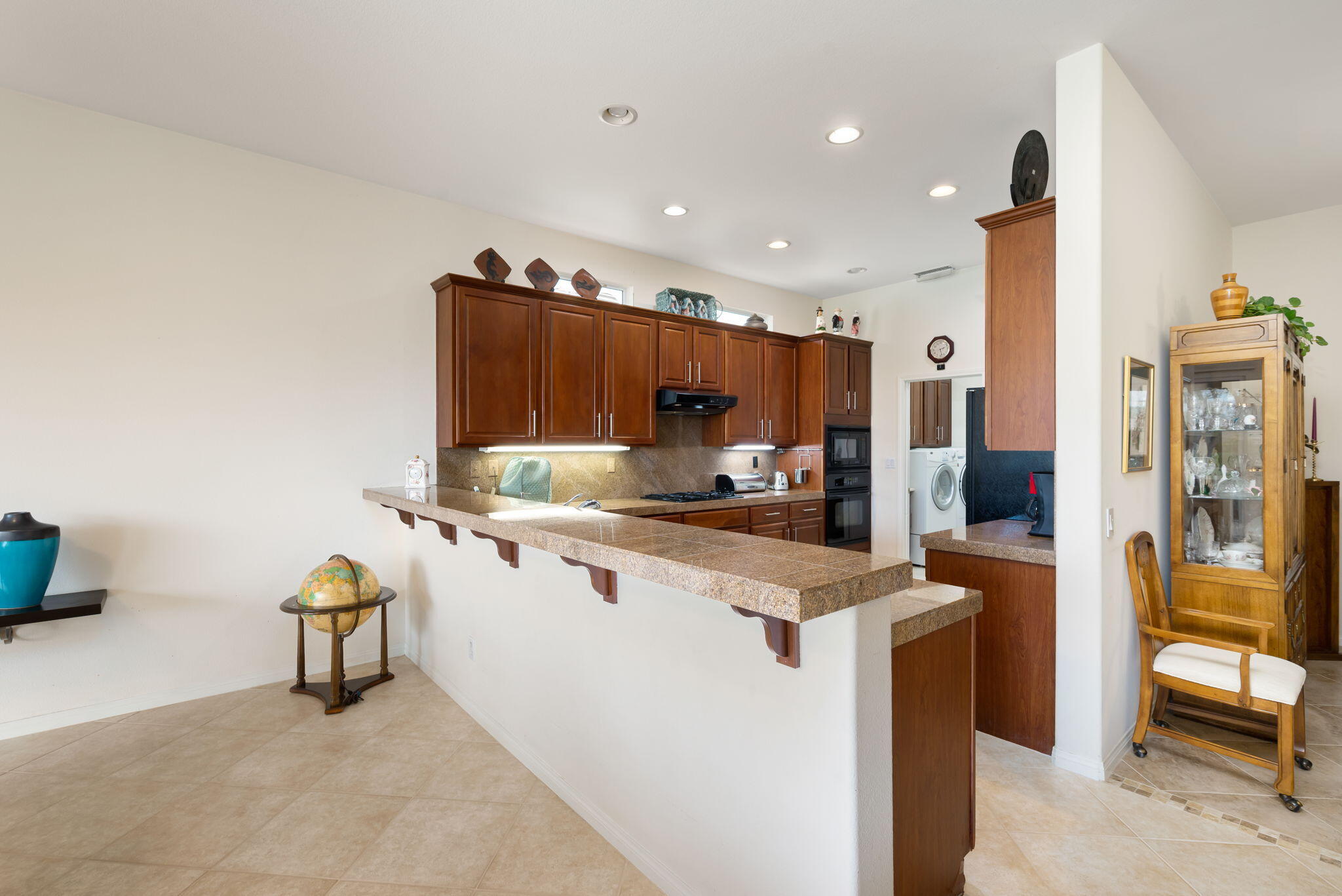 80554 Knightswood Road Indio, CA 92201 - Photo 20 of 44 a kitchen with stainless steel appliances a sink cabinets and wooden floor