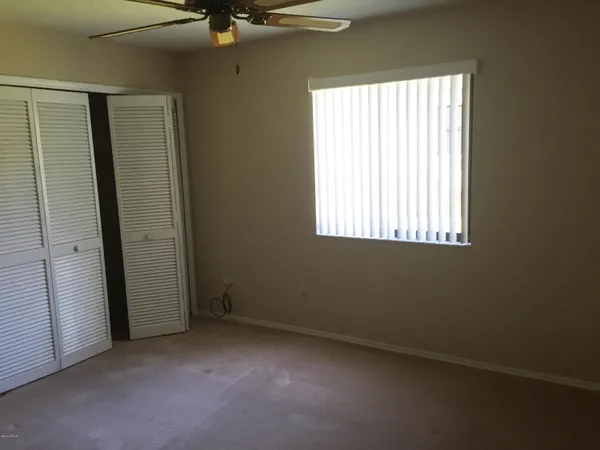 a view of empty room with wooden floor and floor to ceiling window