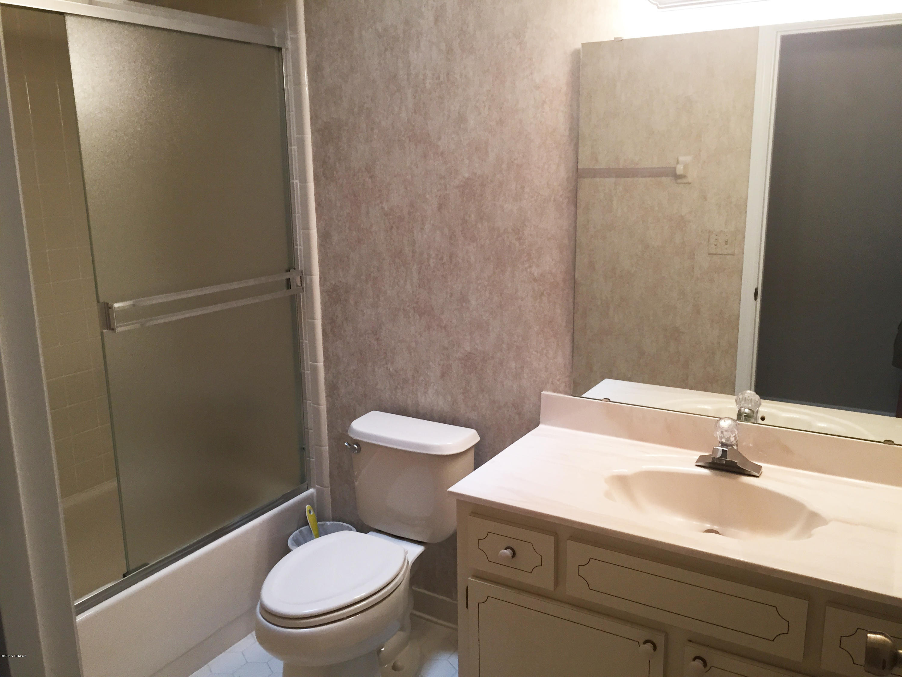 18 Mayfield Terrace Ormond Beach, FL 32174 - Photo 12 of 17 a bathroom with a sink a toilet and shower