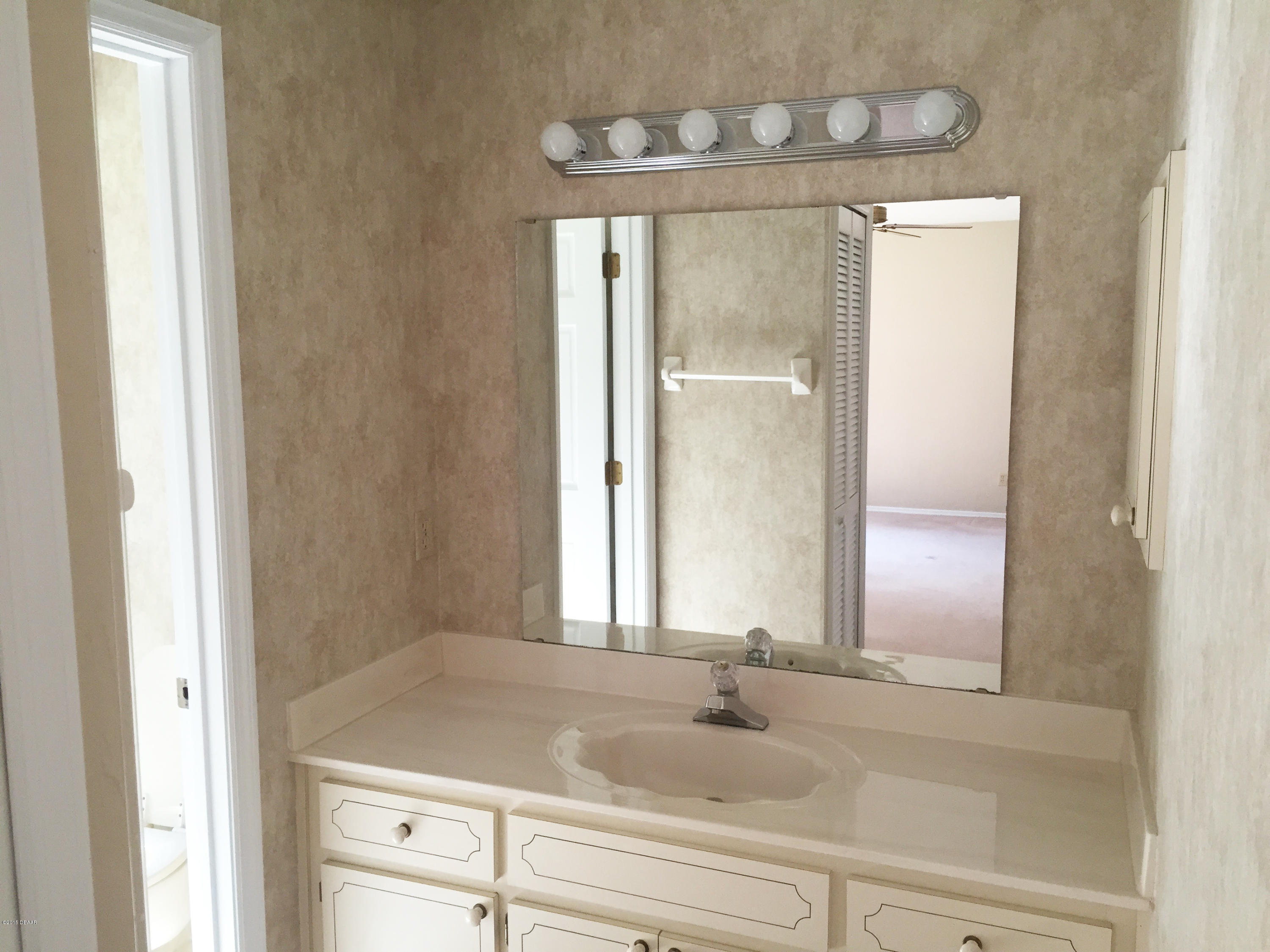 18 Mayfield Terrace Ormond Beach, FL 32174 - Photo 8 of 17 a bathroom with a sink and a mirror