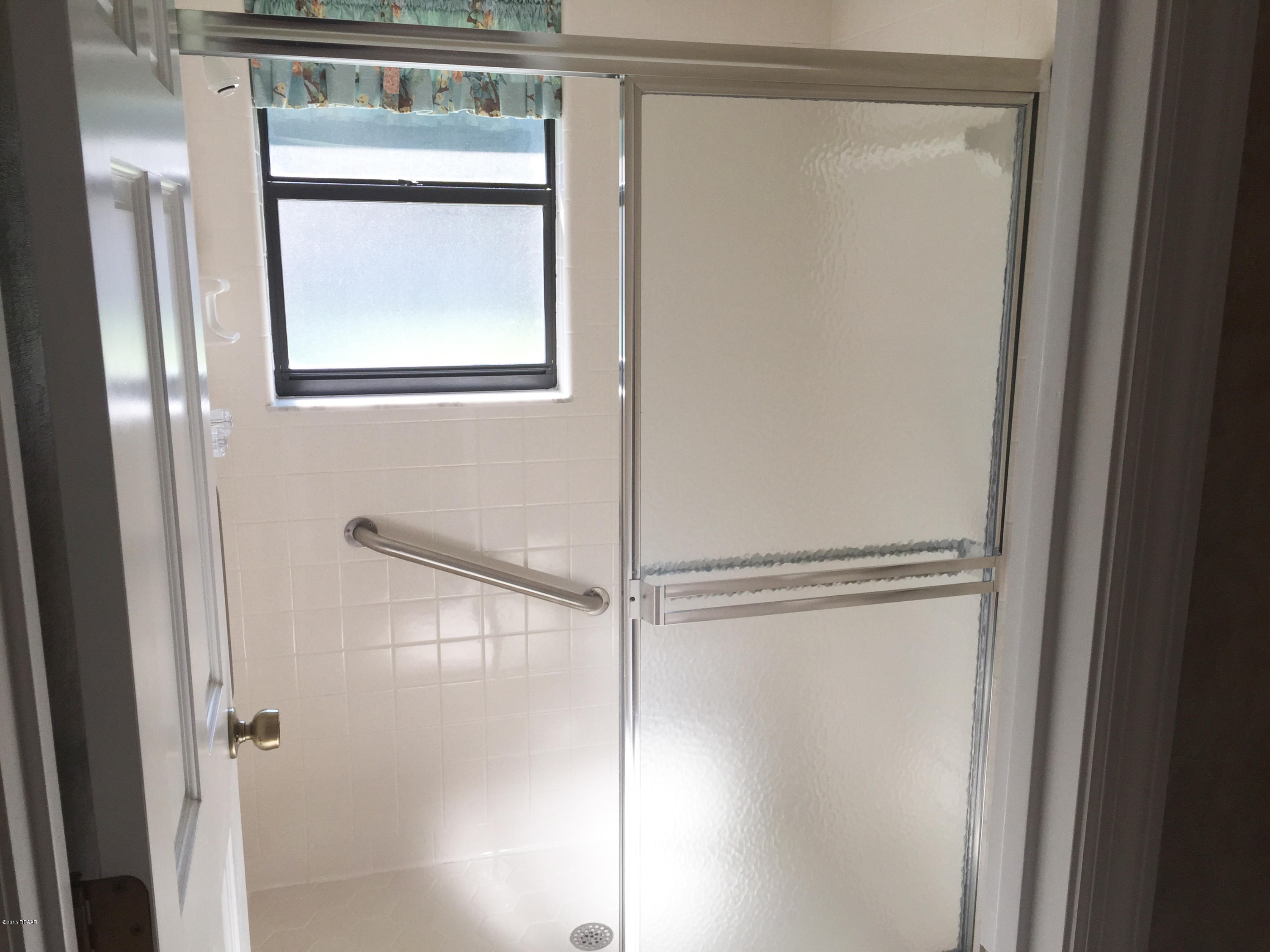 18 Mayfield Terrace Ormond Beach, FL 32174 - Photo 9 of 17 a bathroom with a glass shower door