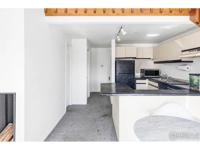a kitchen with kitchen island a sink stainless steel appliances and cabinets