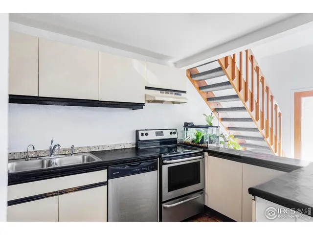 a kitchen with stainless steel appliances granite countertop a sink and a stove