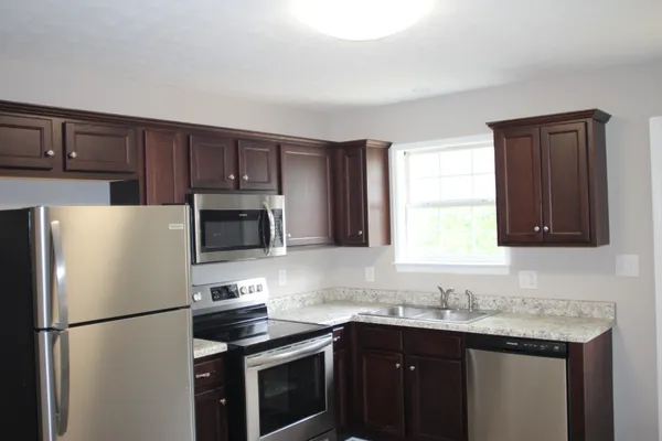 a white refrigerator freezer sitting in a kitchen