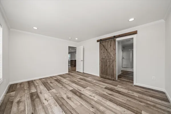 a view of empty room with wooden floor