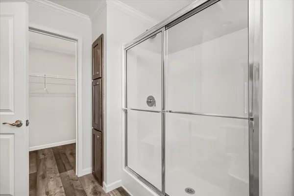 a bathroom with a glass shower door