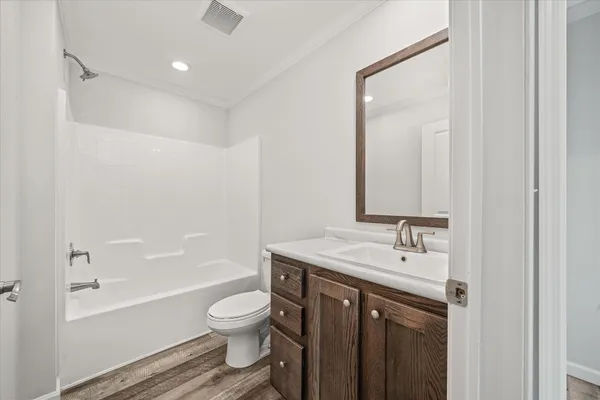 a bathroom with a sink toilet tub and shower