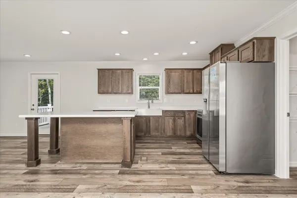 a kitchen with stainless steel appliances granite countertop a refrigerator and a stove