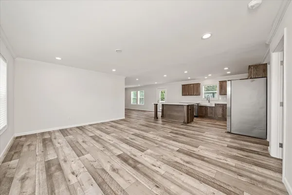 a view of empty room with wooden floor