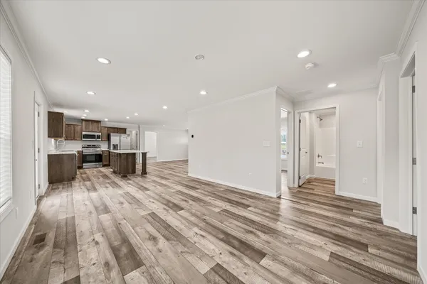 a view of kitchen with kitchen island sink and refrigerator