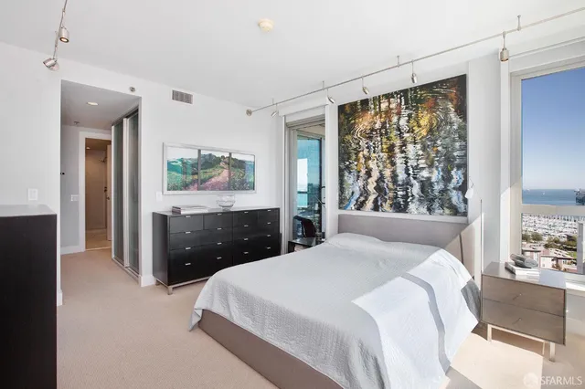 a bedroom with a large bed and a large window