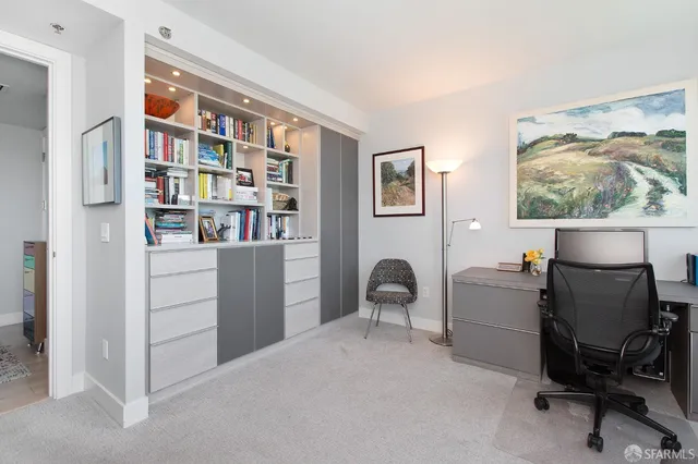 a workspace with furniture and a bookshelf