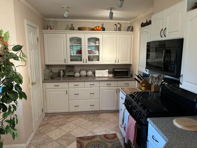 a kitchen with granite countertop a sink and a stove