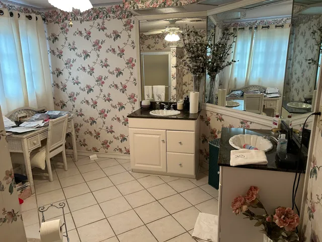 a bathroom with a sink toilet and mirror