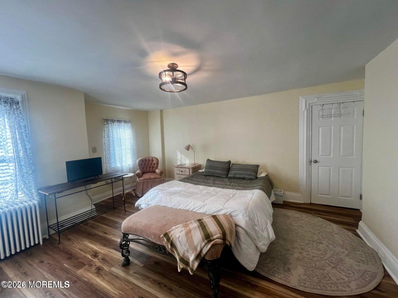 27 Spring Street Freehold, NJ 07728 - Photo 12 of 40 a bedroom with a bed and a chandelier