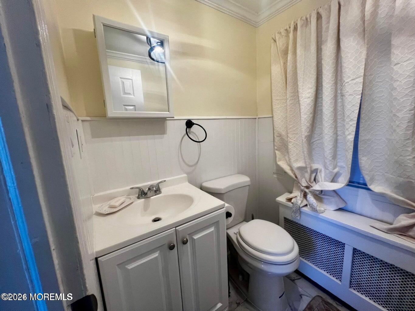 27 Spring Street Freehold, NJ 07728 - Photo 14 of 40 a bathroom with a sink vanity mirror and toilet