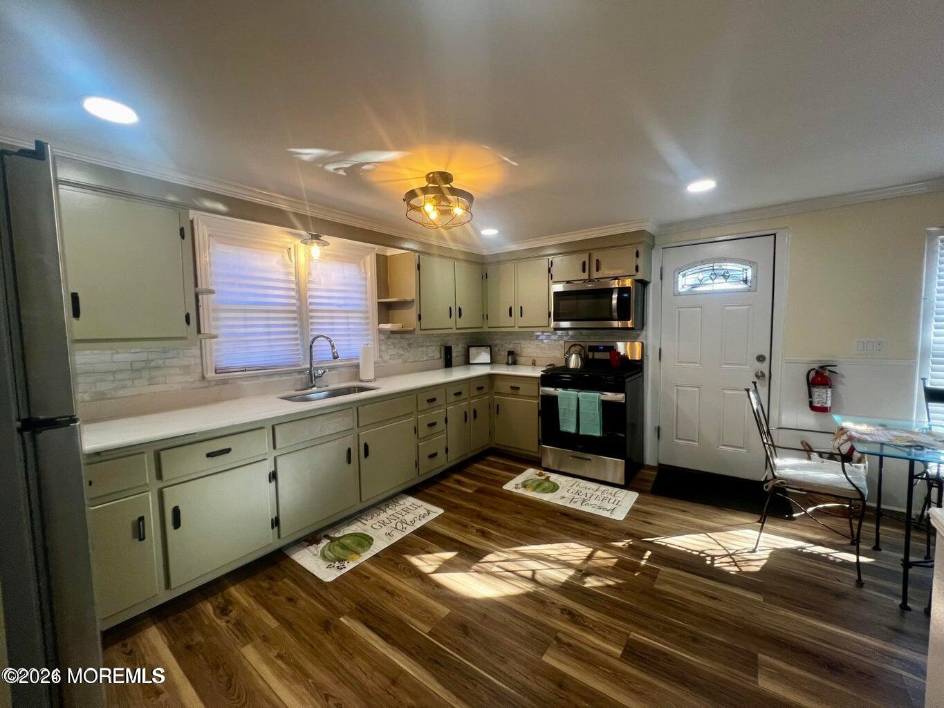27 Spring Street Freehold, NJ 07728 - Photo 5 of 40 a kitchen with stainless steel appliances granite countertop a refrigerator and a stove top oven