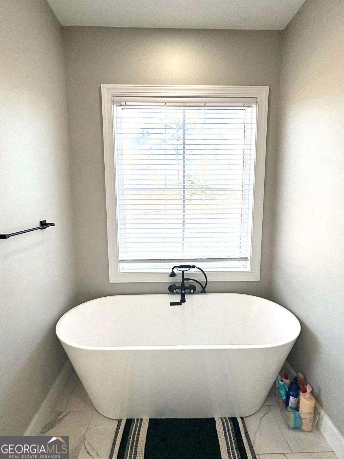 134 Austin Way Vidalia, GA 30474 - Photo 35 of 41 a white bath tub sitting in a bathroom next to a window