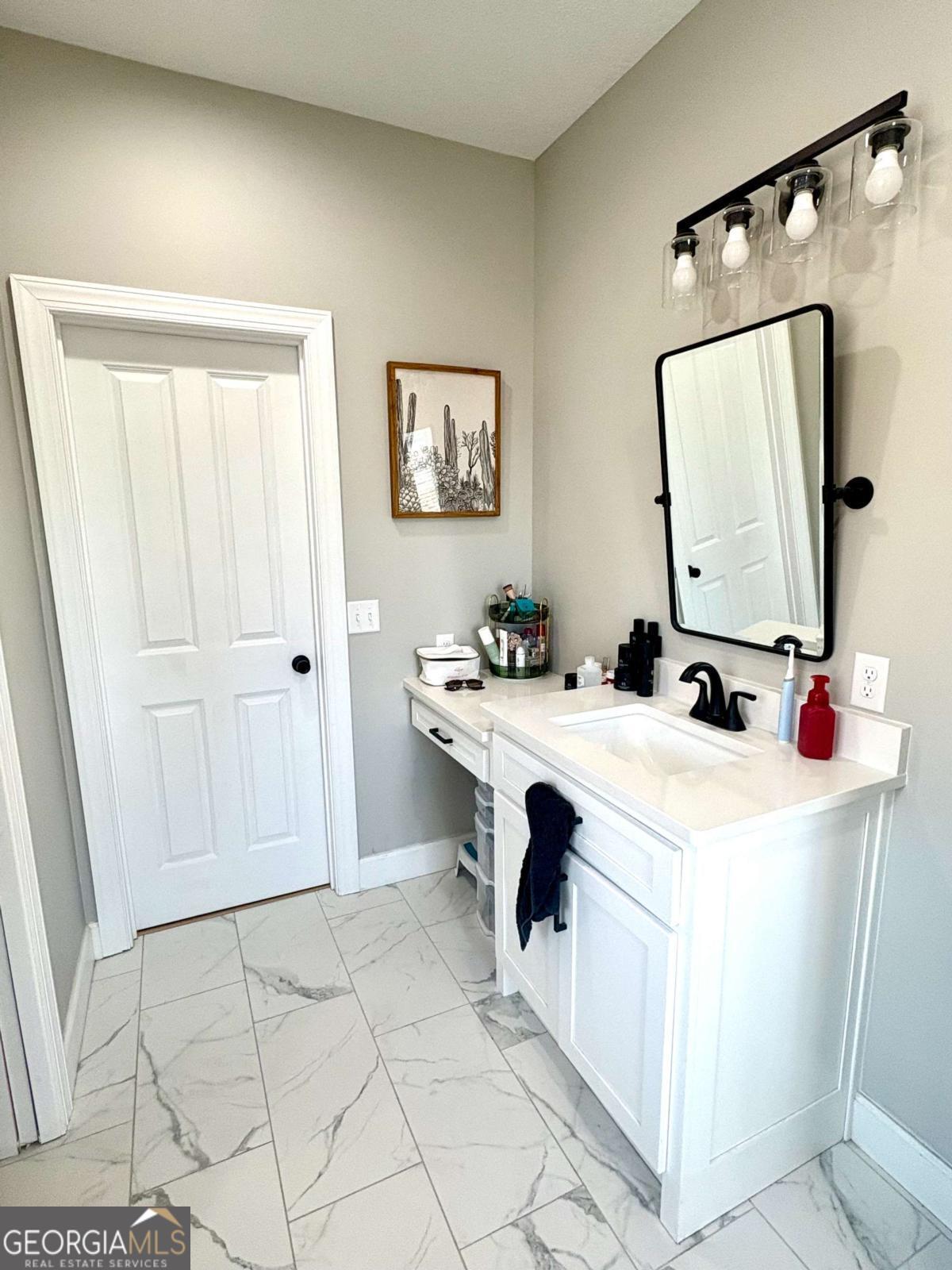 134 Austin Way Vidalia, GA 30474 - Photo 36 of 41 a bathroom with a sink and a mirror