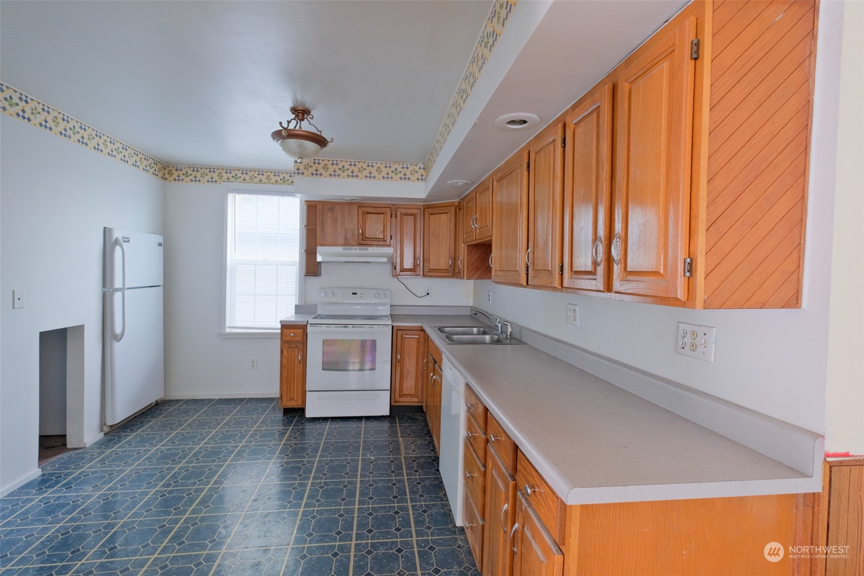 525 Wells Avenue South Renton, WA 98057 - Photo 9 of 25 a kitchen with granite countertop a sink a counter top space stainless steel appliances and cabinets
