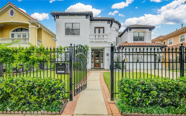 a view of a house with a small yard and plants