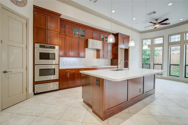a kitchen with stainless steel appliances granite countertop a sink and a stove