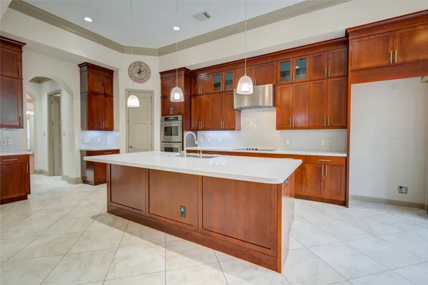 a view of kitchen with stainless steel appliances granite countertop cabinets and window
