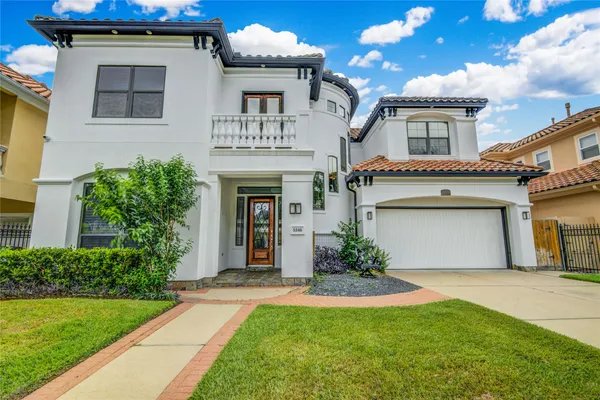 a front view of a house with a garden and garage