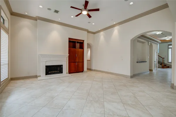 a view of an empty room with a fireplace and a window