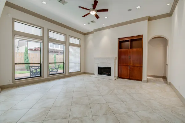 a view of an empty room and window ceiling fan