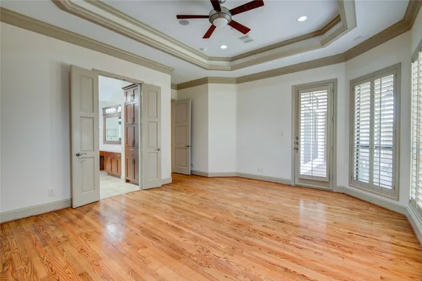 a spacious bathroom with a tub sink and mirror