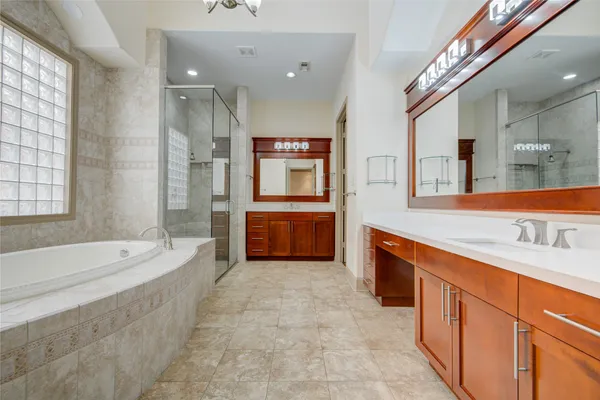 a bathroom with a bathtub a shower and a sink