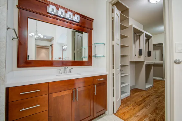 a view of a kitchen with wooden floor and electronic appliances